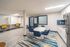 Modern interior with office area, dining table, and stylish kitchen corner.