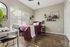 Inviting bedroom featuring a comfortable bed with a purple quilt, modern shelving, and natural light through blinds.