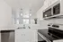 Open-concept kitchen with sleek cabinetry, stainless steel appliances, and elegant lighting.