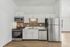 Contemporary kitchen with stainless steel appliances and white cabinetry.