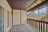 Inviting outdoor balcony with wooden flooring and natural views.