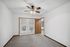 Bright bedroom with carpeted flooring, a ceiling fan, and French doors leading outside.
