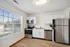 Bright, sleek kitchen with stainless steel appliances and modern cabinetry.