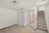 A bright, carpeted stairway leads to a welcoming hallway with modern lighting.