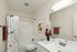 Contemporary bathroom featuring a white vanity, modern fixtures, and stylish decor.