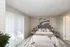 Bright and stylish bedroom with a modern design, featuring a cozy bed, chic artwork, and natural light.