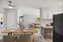 Modern open-layout apartment with a dining area, cozy living room, and sleek kitchen design.