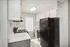Bright and modern kitchen featuring sleek black appliances, white cabinetry, and ample natural light.