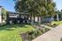 Inviting apartment community entrance with lush greenery and welcoming signage.