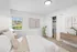 Bright and cozy bedroom with plush bedding, stylish decor, and a peaceful window view.