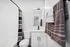 Chic bathroom featuring modern white sink, stylish towels, and a contemporary shower curtain.