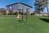 Inviting apartment building with lush green lawn and vibrant landscaping, perfect for families.