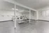 Bright and modern laundry room equipped with multiple washers and minimalistic decor.