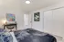 Modern bedroom interior with sleek furniture, artistic wall decor, and soft lighting.