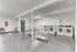 Bright, roomy laundry room with multiple washers and folding stations.