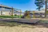 Outdoor playground with vibrant swings and slides, set in a cozy apartment complex.