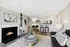 Inviting and modern living room with a cozy fireplace, sleek furniture, and open dining area.