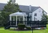 Elegant residential complex with a classic white and black gazebo on green lawns.