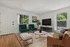 Modern living room with elegant furniture, large windows, and stylish decor.