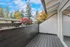 Inviting balcony with sleek black railing and a view of colorful autumn trees.
