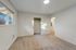 Spacious bedroom with a built-in closet, carpeted floor, and large window offering ample natural light.