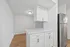 Sleek kitchen area with modern cabinetry, stainless steel appliances, and elegant white countertops.