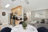 Contemporary open-concept kitchen and living room with elegant furnishings and natural light.
