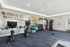 Spacious gym with exercise bikes, colorful medicine balls, and a variety of fitness equipment.