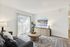 Inviting living room with a plush gray sofa, stylish wooden coffee table, and large flat-screen TV.