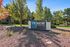 Inviting entrance sign for ReNew Flagstaff East surrounded by lush greenery and vibrant trees.