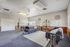 Elegant living room with modern furnishings, featuring grey sofas, a stylish rug, and artistic decor elements.