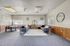Spacious living room with modern sofas, stylish dining area, and natural light.