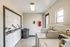 Modern laundry room with washers, dryers, and ample natural light.