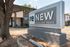 Exterior view of Renew Highland Park leasing office with modern signage and landscaping.