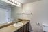 Modern bathroom with elegant fittings, spacious countertop, and large mirror.