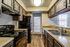 Modern kitchen featuring sleek black appliances, stylish cabinetry, and abundant natural light.