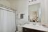 Modern bathroom featuring sleek fixtures, stylish vanity, and neutral decor.