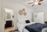 Inviting bedroom with plush bedding, neutral decor, and an adjoining modern bathroom.