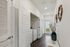Bright hallway featuring modern decor, a stylish vase, and a convenient laundry area.
