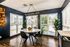 Bright dining area with sleek round table, modern chairs, and ambient lighting.