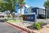 Inviting exterior view of ReNew Andrews Apartments with lush landscaping and a welcoming entry sign.