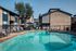 Inviting outdoor pool area with lounge chairs at a modern apartment complex.