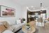 Bright and airy living room with a sleek kitchen, modern decor, and comfortable seating area.