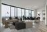 Luxurious modern apartment living room with floor-to-ceiling windows showcasing stunning skyline views. Stylish open-concept design featuring a comfortable sofa, elegant dining area, and chic decor.