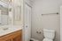 Pristine bathroom featuring a sleek vanity, elegant lighting, and ample storage, perfect for modern living.