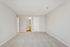 Bright and spacious room with plush carpet, neutral walls, and a convenient ensuite bathroom, perfect for modern living.