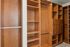 Luxurious walk-in closet with elegant wooden shelving and ample storage space.