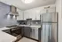 Modern kitchen with sleek stainless steel appliances, elegant cabinetry, and stylish tile backsplash.
