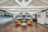 Elegant open-concept living space with vaulted ceilings and modern decor, featuring cozy seating and a stylish fireplace.