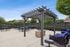 Chic outdoor patio featuring a stylish pergola, modern seating, and a cozy fire pit, perfect for entertaining.